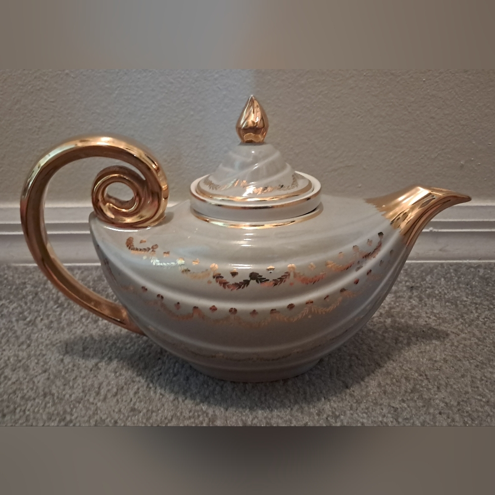 Elegant Cream and Gold Ceramic Teapot with Artistic Design